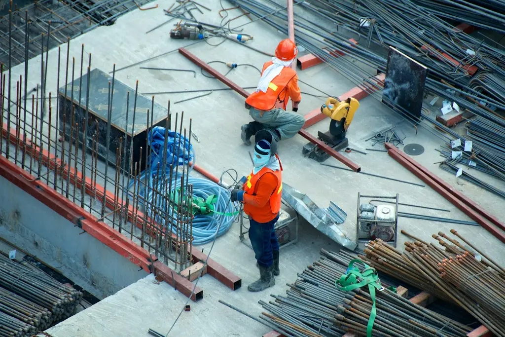 Construction workers in high-visibility clothing on a building site