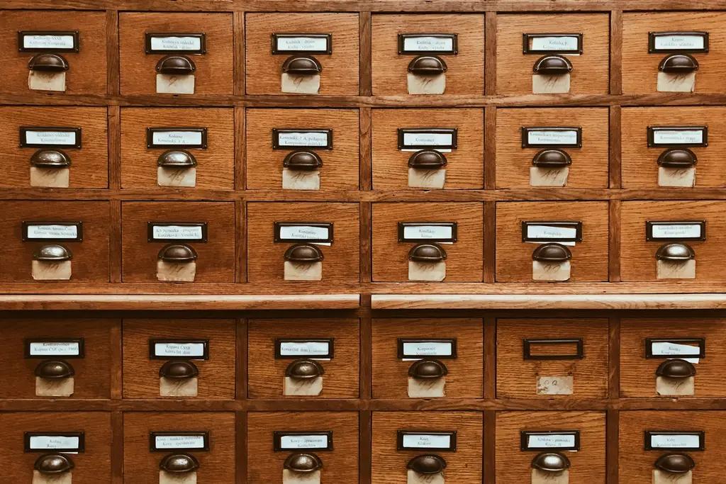 Rows of labelled wooden index drawers, representing organised data