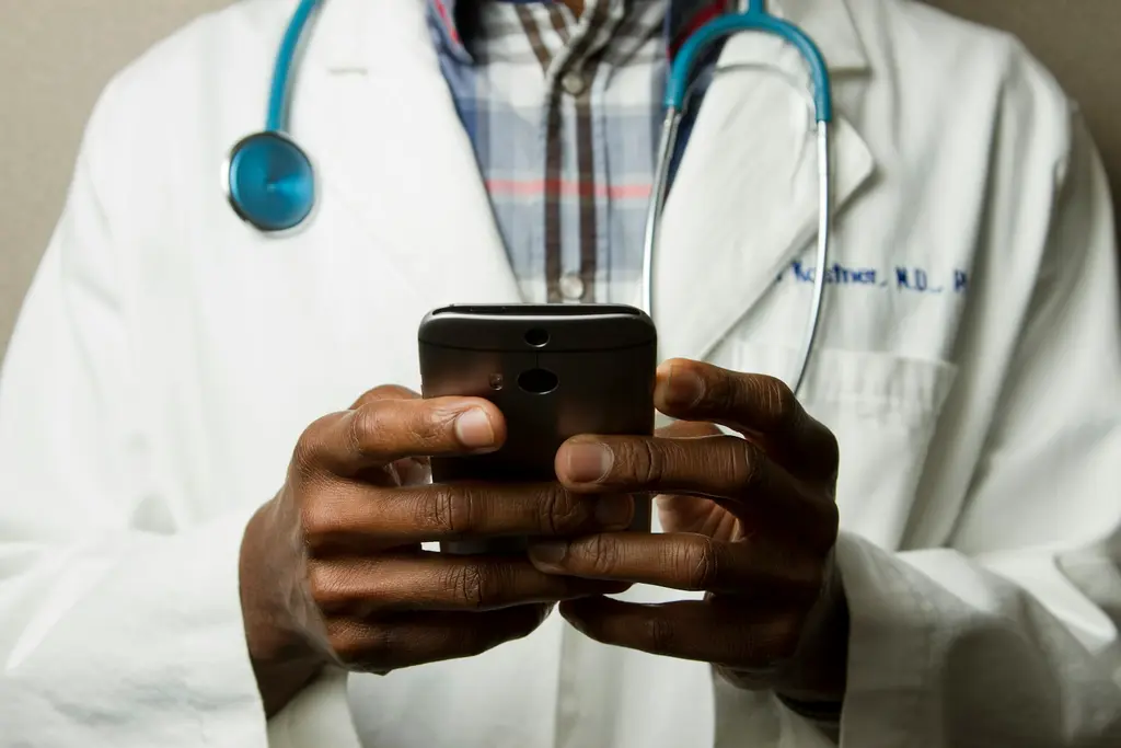 A healthcare professional in a white coat with a stethoscope