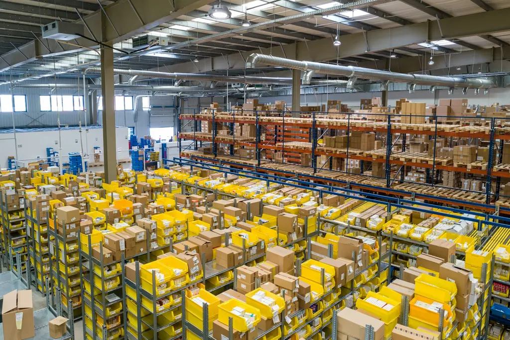 A large warehouse with rows of shelving and stock