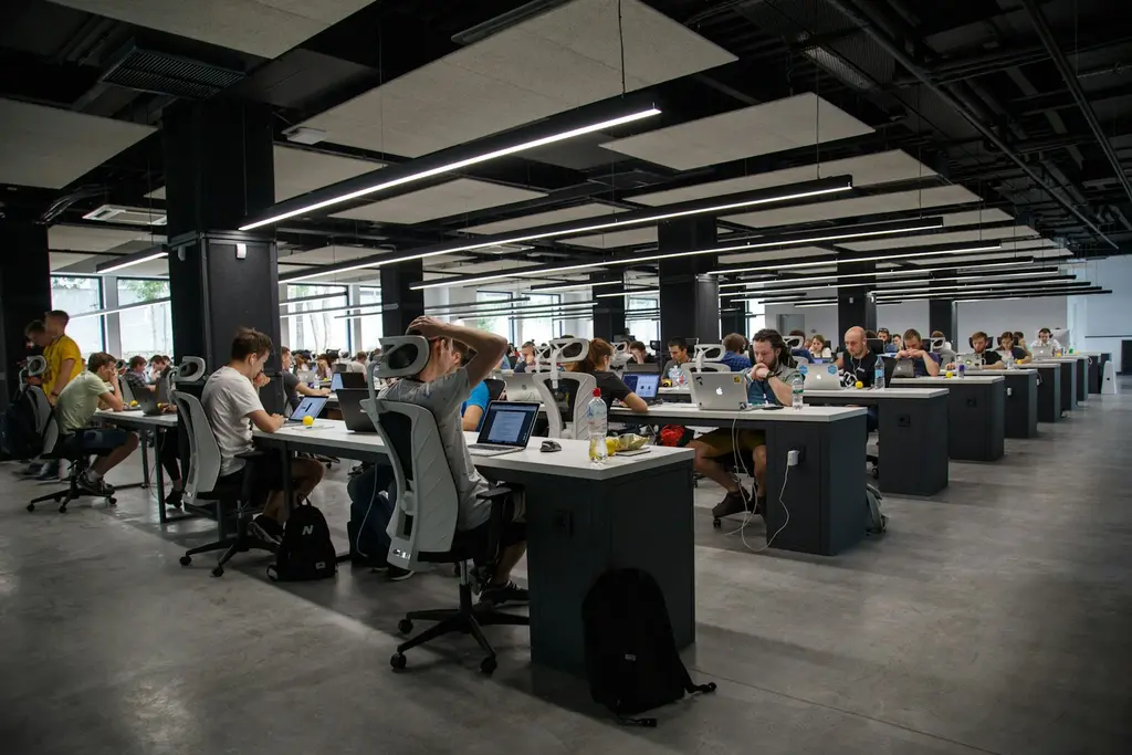 A large open-plan office with many people working at desks