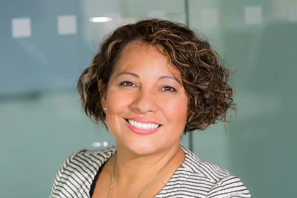 A smiling professional woman in a bright workplace
