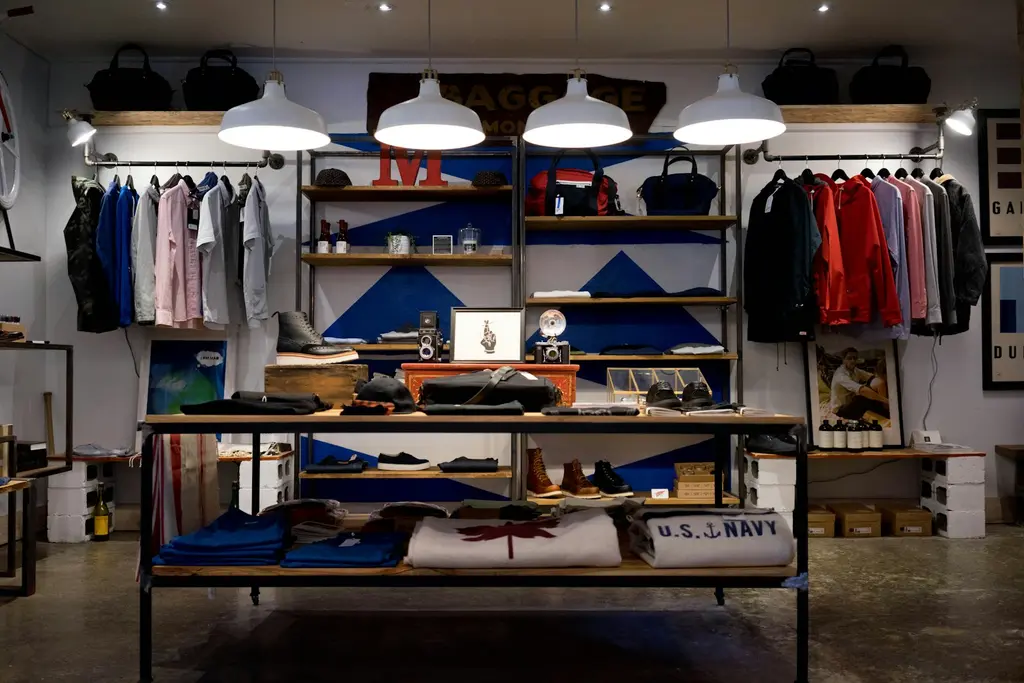 A clothing shop interior with shelves of folded garments